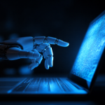 A robotic hand reaching toward a glowing laptop screen in blue light