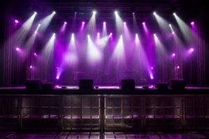 A concert stage lit with purple and white spotlights and atmospheric haze